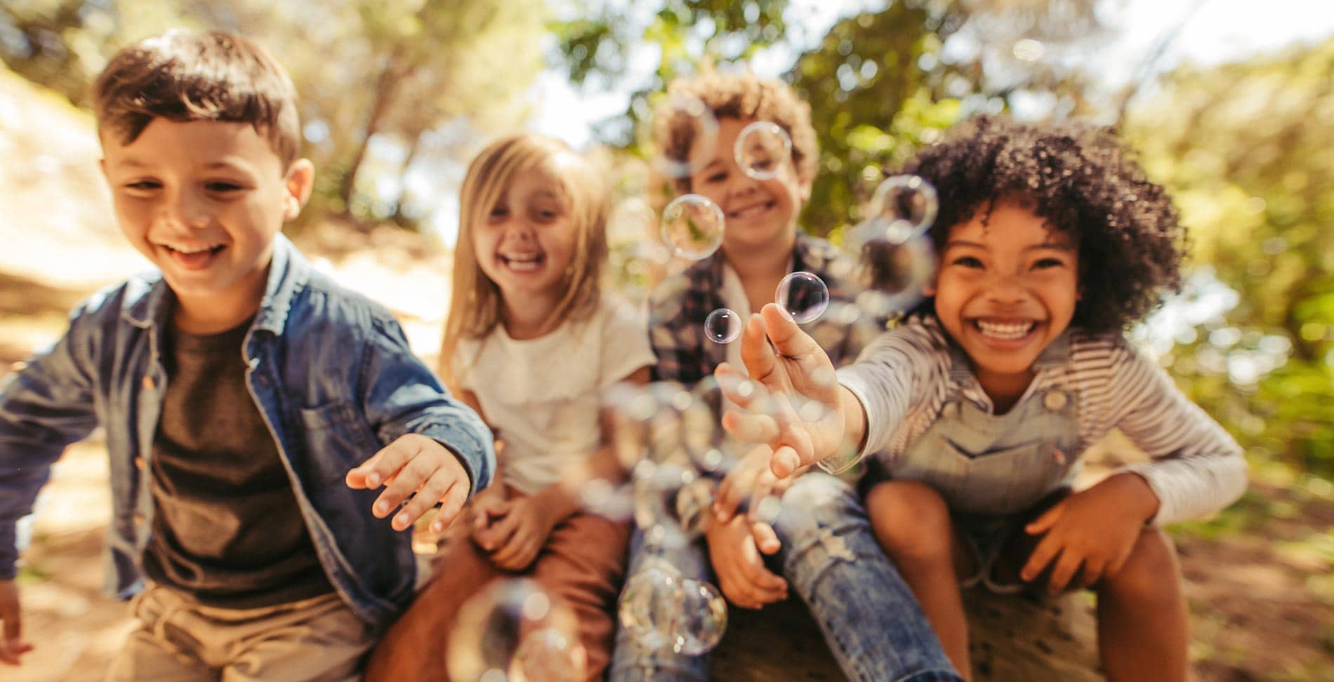 kids outside popping bubbles