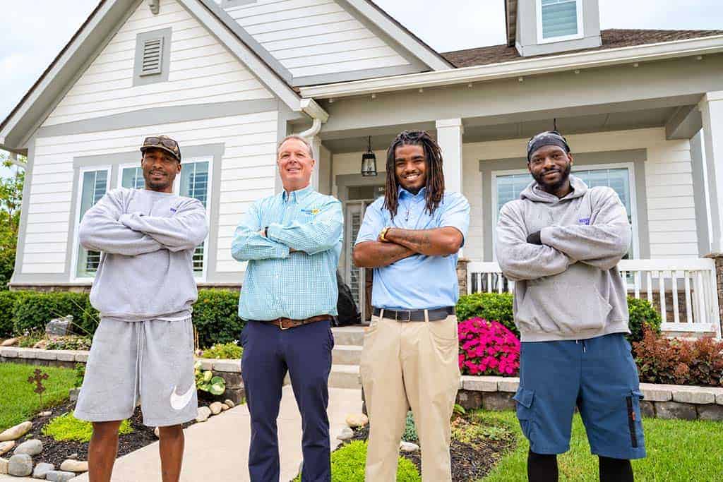 Crew at Client Home Moves For Less crew standing in front of a client's home