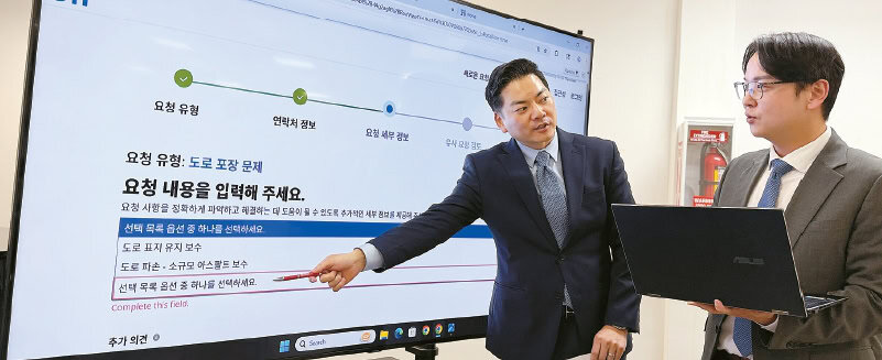 James Ahn and Steve Kang explain Koreatown pothole reporting methods at a press briefing in Los Angeles