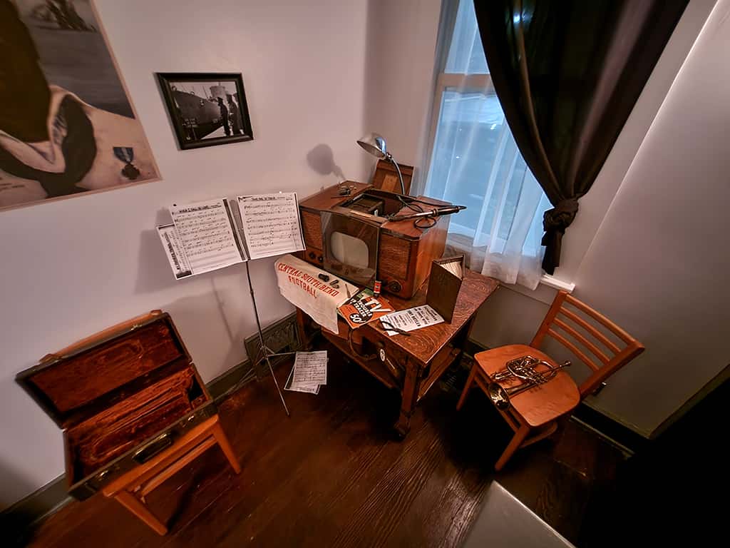 alcove Vintage radio and sheet music display in The History Museum room.