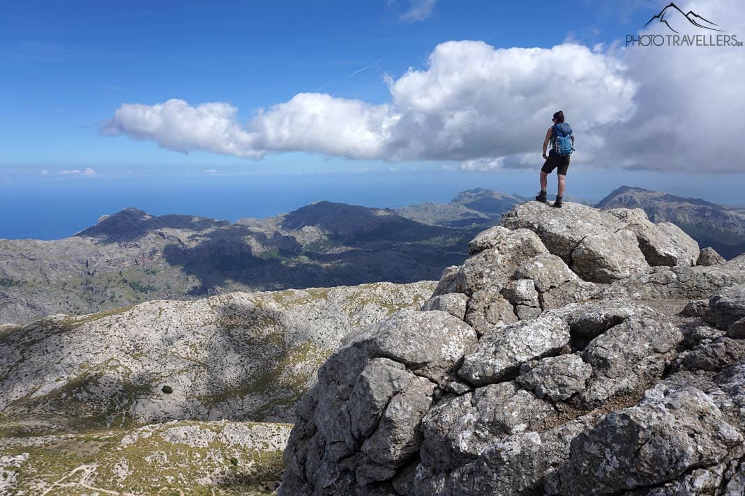 Reisebloggerin Biggi Bauer steht auf dem Gipfel der Massanella und blickt über die Berge Mallorcas und auf das Meer