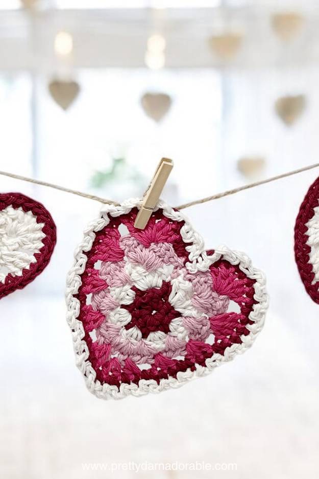 pink striped granny stitch hearts with picot trim hanging on a garland