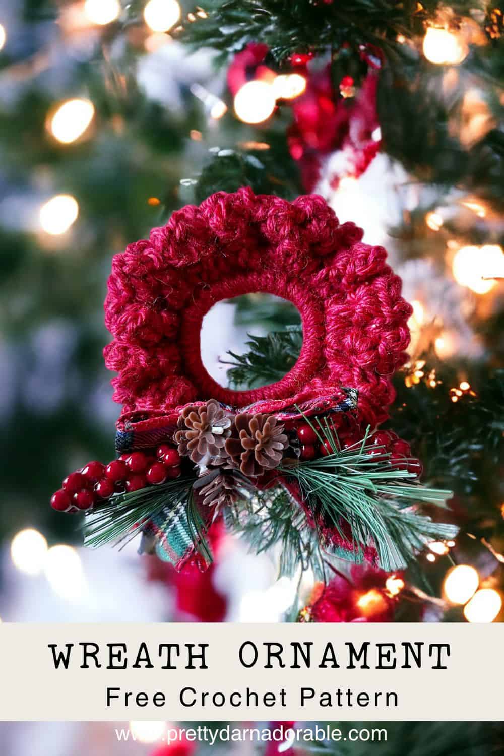 red mini crochet wreath ornament hanging on a tree