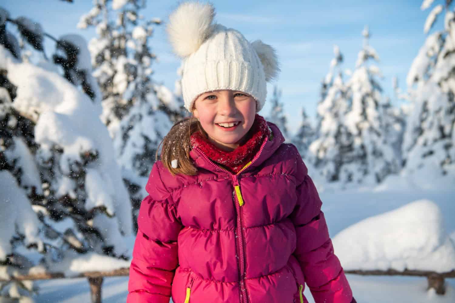 Portrait of a Beautiful Girl Delighting in Sunlight Amidst Snowy Peaks.