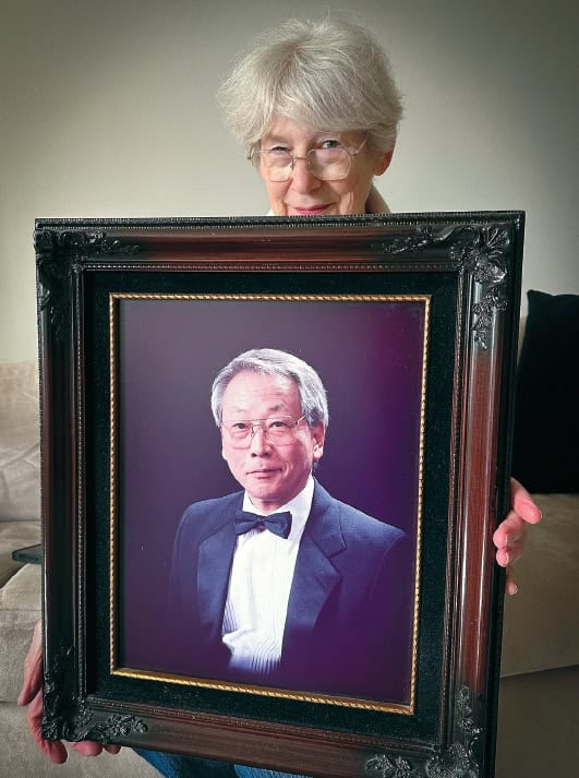 Carol Min holds photo of Min Byung-Soo after LA riots