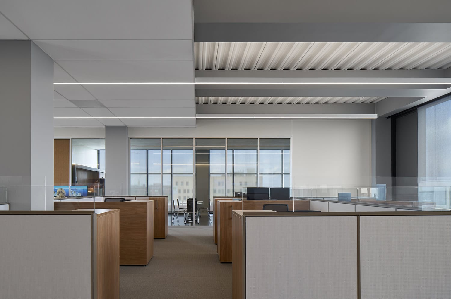 Interior view of workstations and glass-enclosed meeting room at Heartland Headquarters in Oklahoma City.