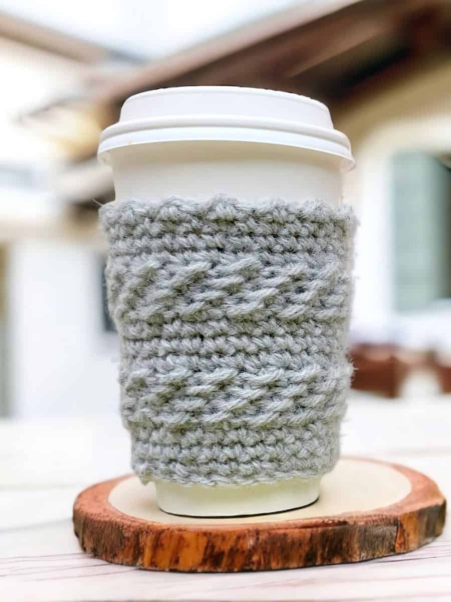 crochet cozy on a coffee cup in the montero texture