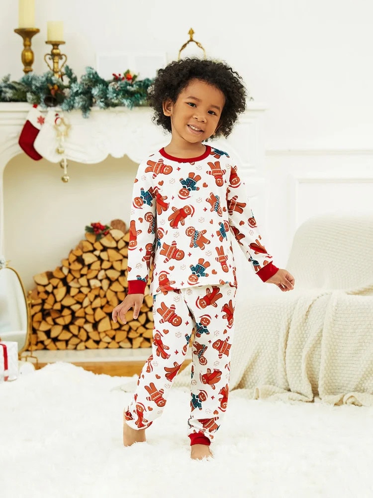 Family Xmas Pajamas l ittle boy wearing Christmas PJs with a gingerbread man print
