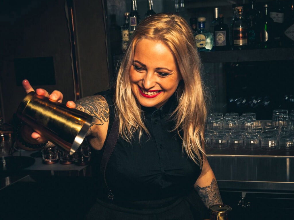 Bartender serves sweet wine with origin from Neusiedlersee DAC.