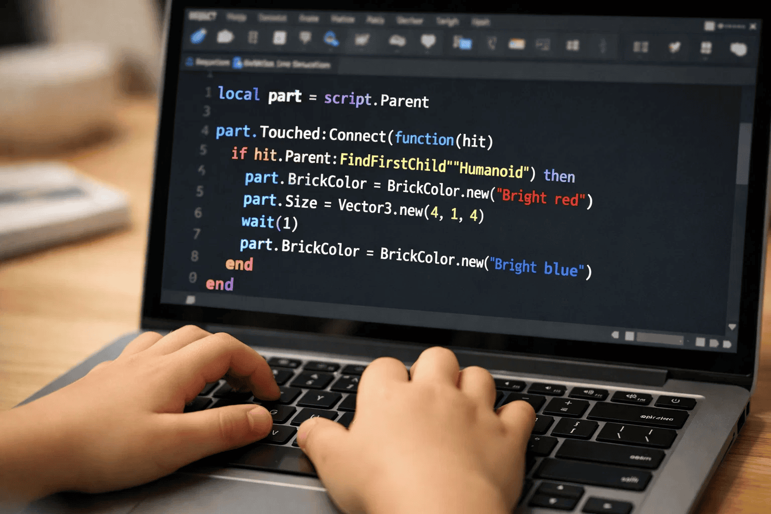 Child learning Lua coding language on laptop using Roblox Studio game development tool