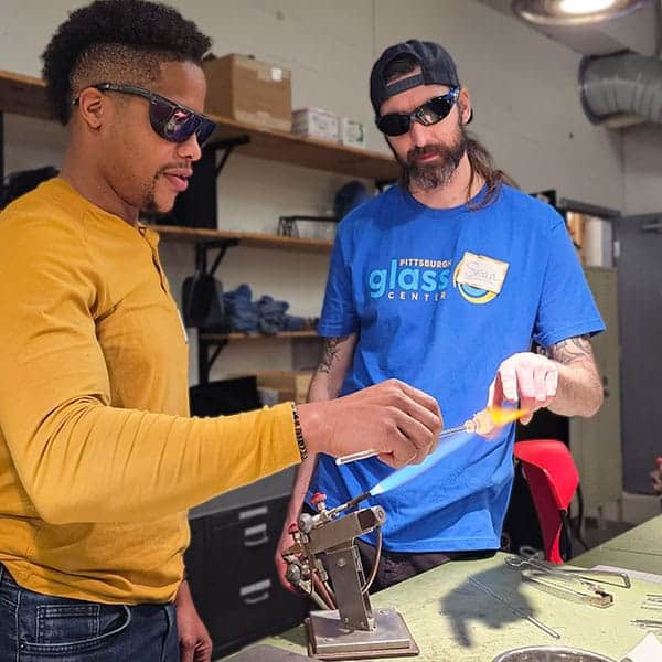 Flameworking instructor with student at Pittsburgh Glass Center