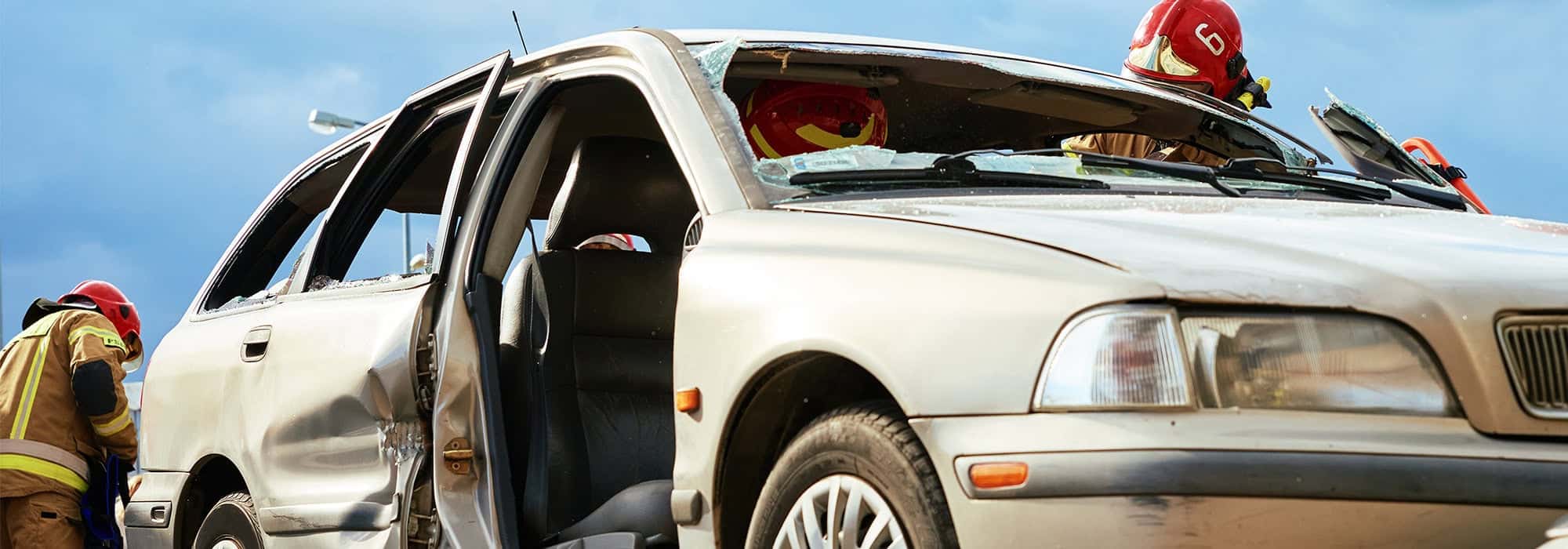 Firefighters working on vehicle after accident