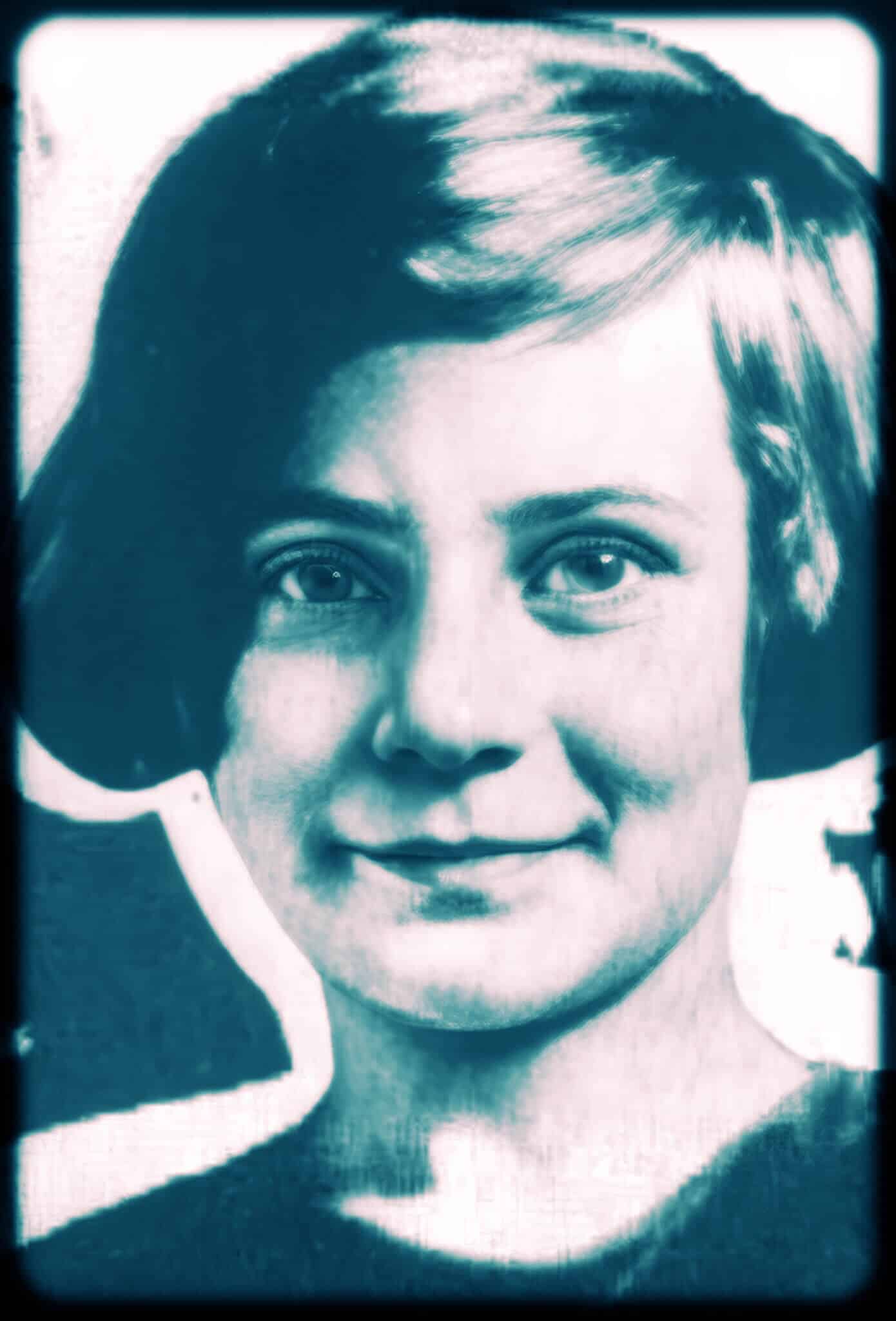 Black-and-white portrait of a young girl with short hair, smiling slightly.
