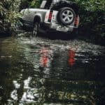 A car parked on the side of a river