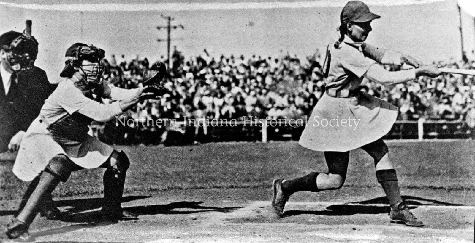 AAGPBL batter and catcher ph 7424794 Female baseball catcher reaching for ball during game, vintage black and white photo.