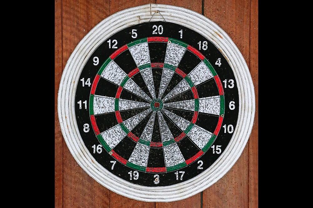 Paper dart board with lots of holes