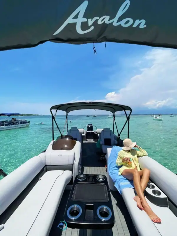 Lady relaxing on a Pontoon Boat at Crab Island Destin Florida, how do I get to Crab Island, when is the best time to visit Crab Island