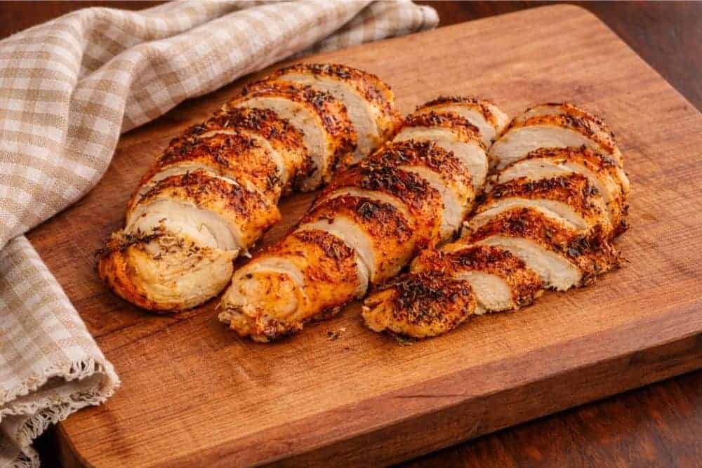Slow Cooker Split Chicken Breasts Sliced on a Cutting Board