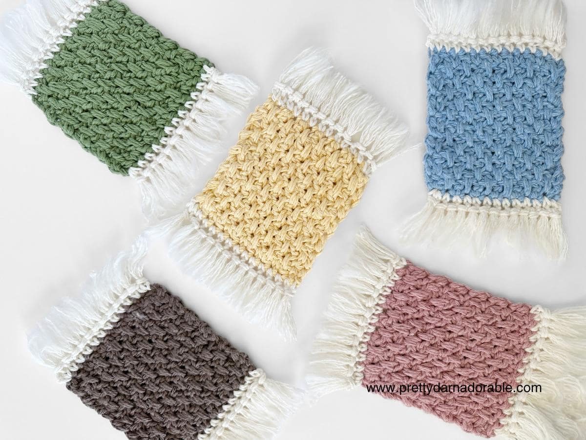 multiple coloured crochet mug rugs with fringe
