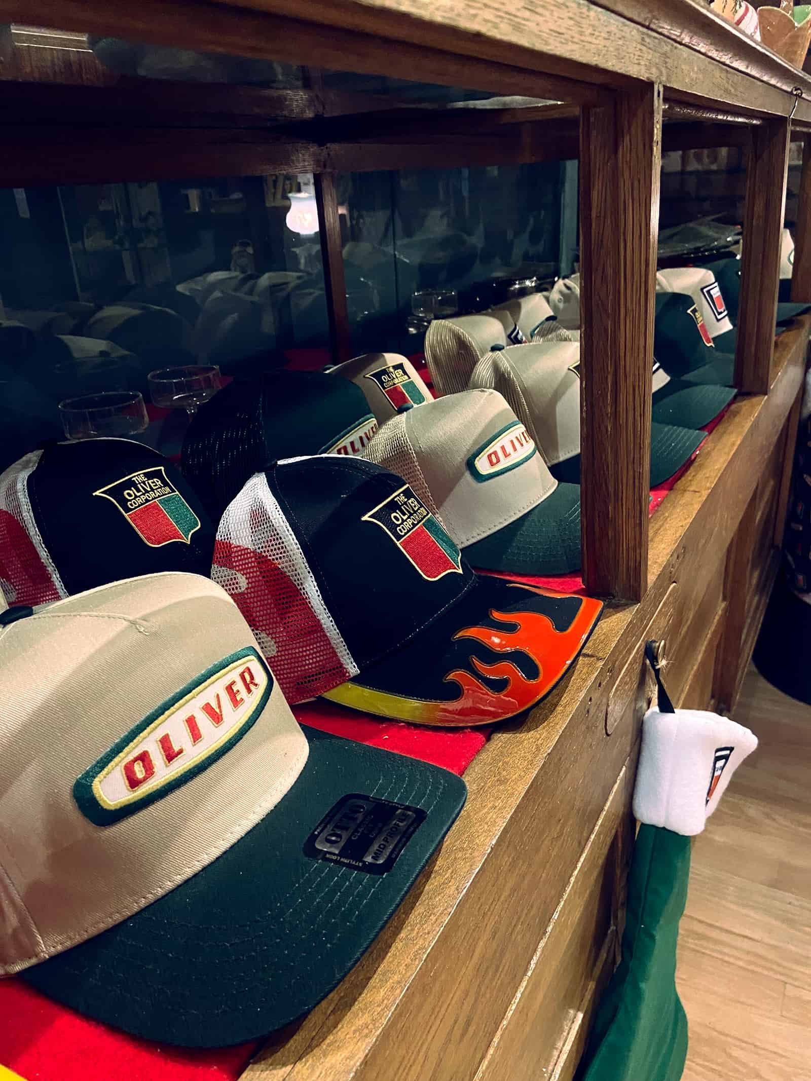 IMG_2646 Vintage Oliver Racing caps displayed at The History Museum showcasing automotive history and memorabilia.