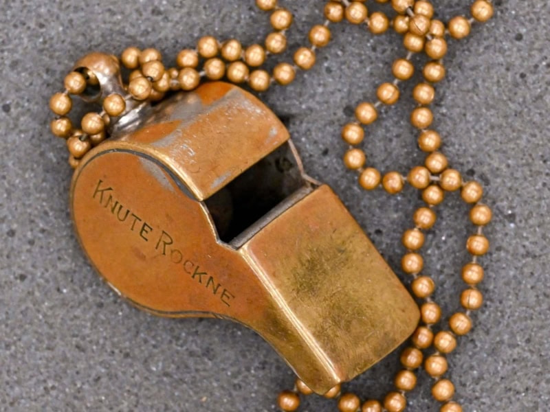 rockne_whistle Vintage keyteller with a string of beads, showcasing historical artifacts at The History Museum.