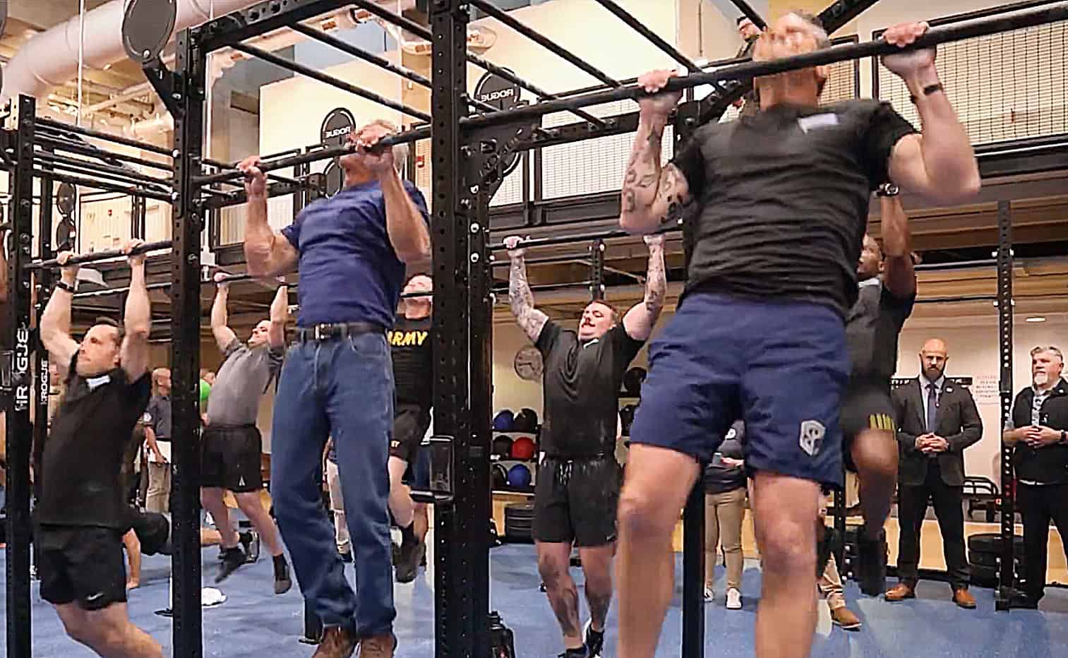 Robert F. Kennedy Jr. on the left and Pete Hegseth on the right doing pull-ups in the Pete and Bobby Challenge