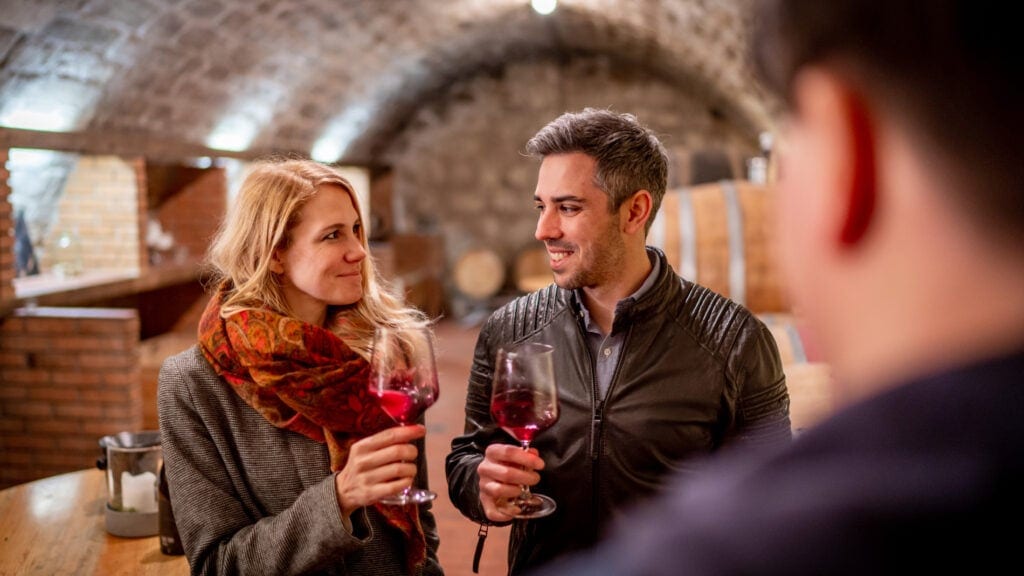 Two people tasting wine in a wine cellar at Lake Neusiedl.