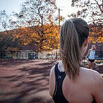 Coach Becky on a track with group of athletes