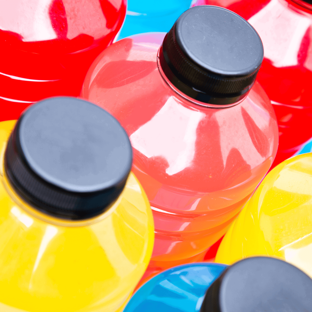 Colorful sports drink bottles with black caps.