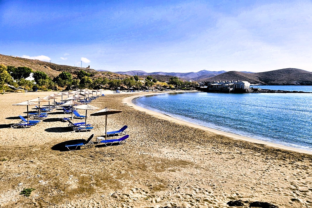 Sandstrand Katsouni mit blauen Liegen und Sonnenschirmen