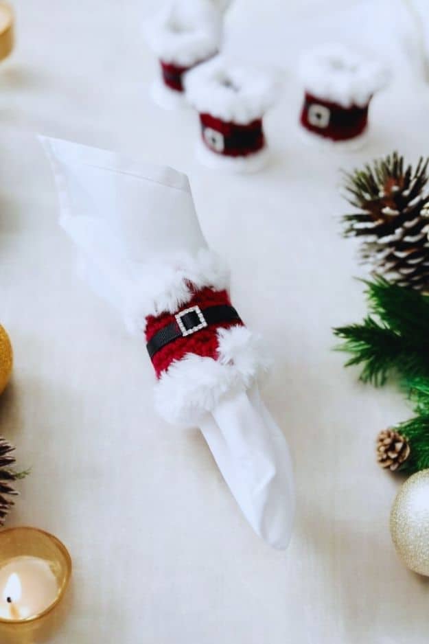 red napkin ring with white fur trim with black belt and rhinestone buckle