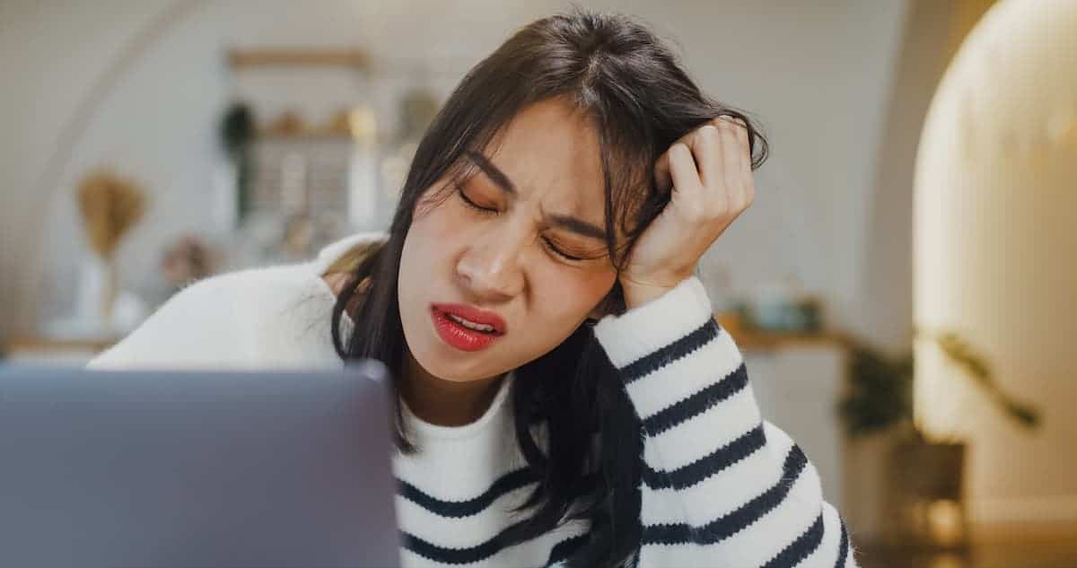 woman looking stressed in front of computer