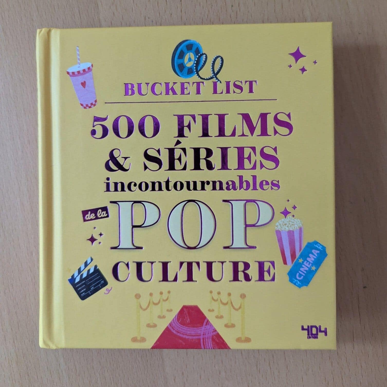 Guide des films et séries incontournables de la culture pop, couverture illustrée avec des éléments liés au cinéma, pop-corn et tickets, parfait pour les amateurs de divertissement et de cinéma.