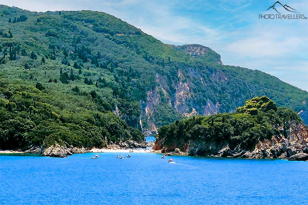 Der schmale Sandstreifen der Liapades Beach fügt sich zwischen begrünten Felsen in die Umgebung