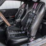 A motorcycle parked on the trunk of a car