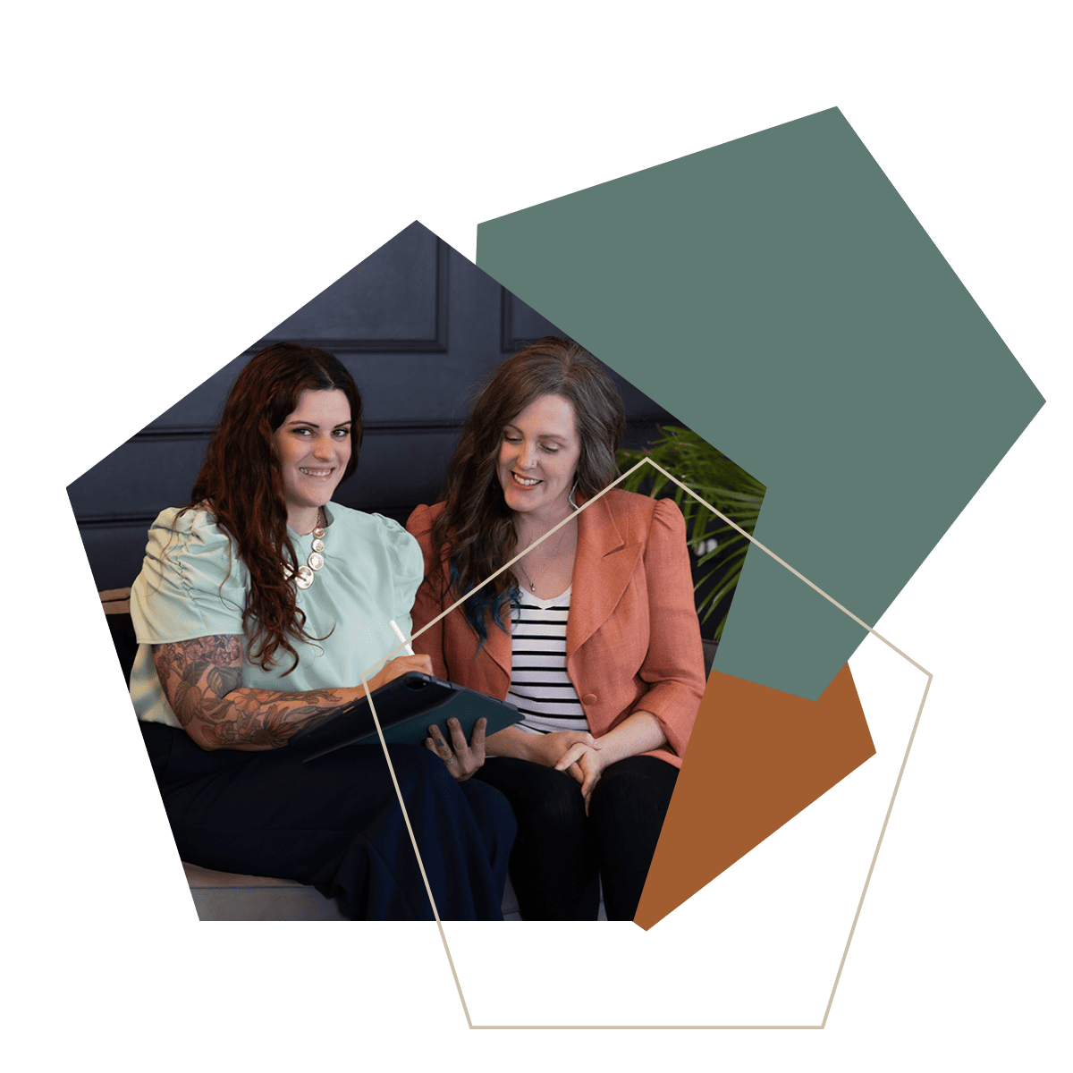 Two women collaborating on a tablet during a business operations strategy meeting.