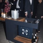 A group of people standing around a table