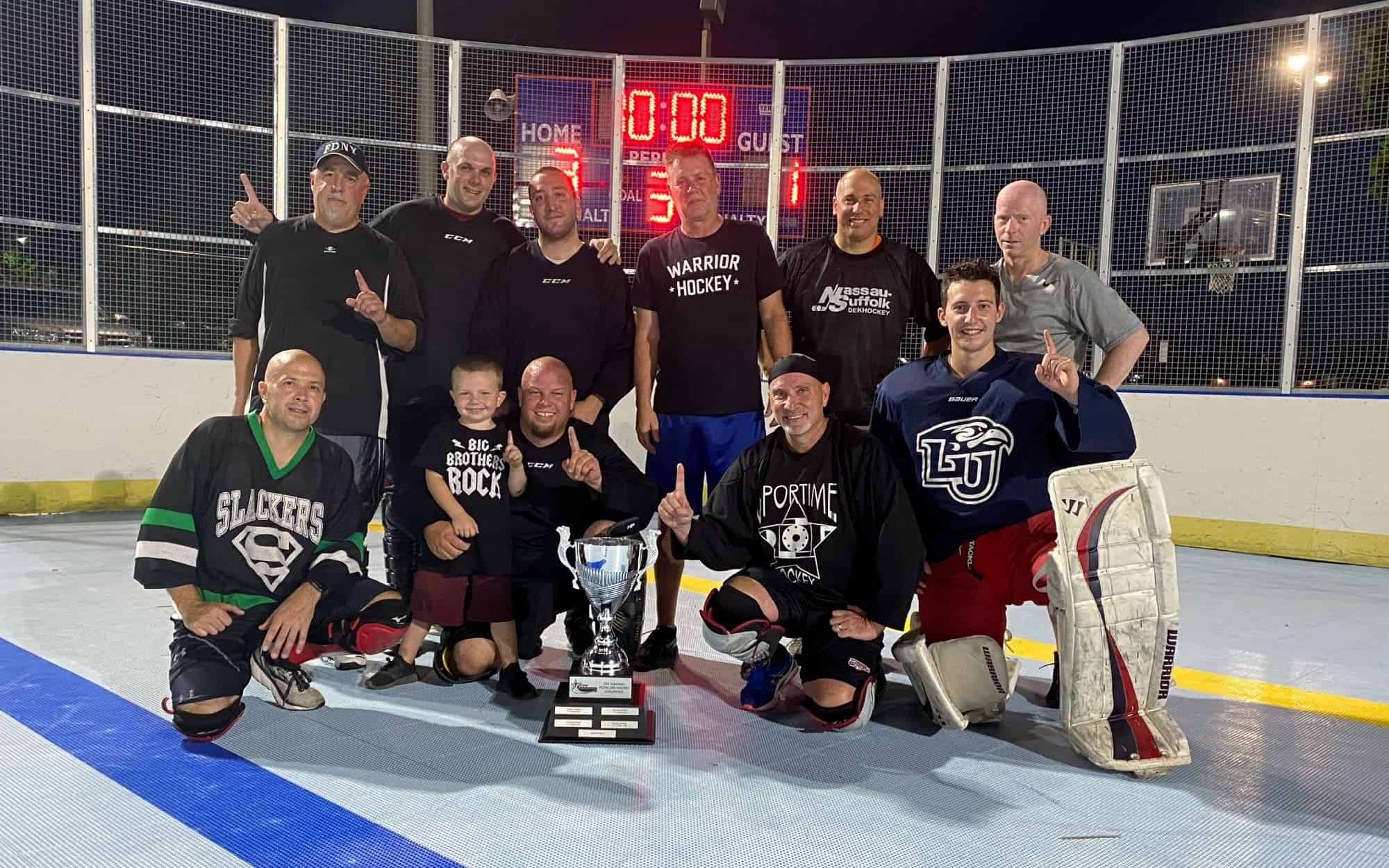 An adult dek hockey team poses for a team photo.