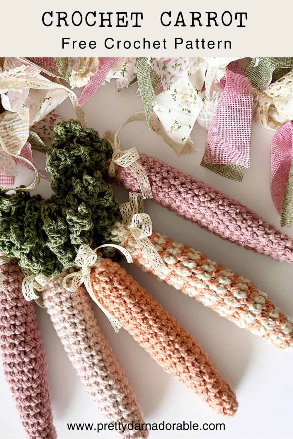 group of crochet carrots with green tops in solid and stripes with a garland