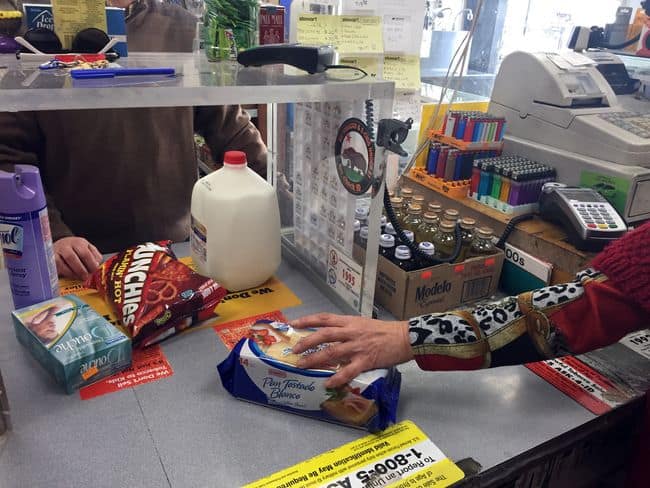 The State Board of Equalization is becoming increasingly thorough with its screening process when monitoring taxes for various businesses. A customer at a market is making a purchase.
