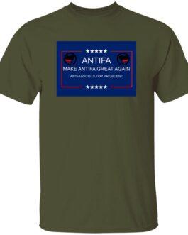 Olive green "Make Antifa Great Again" t-shirt. The design features the Antifa symbol, stars, and the slogan "Anti-Fascists for President" in red, white, and blue on a dark background.