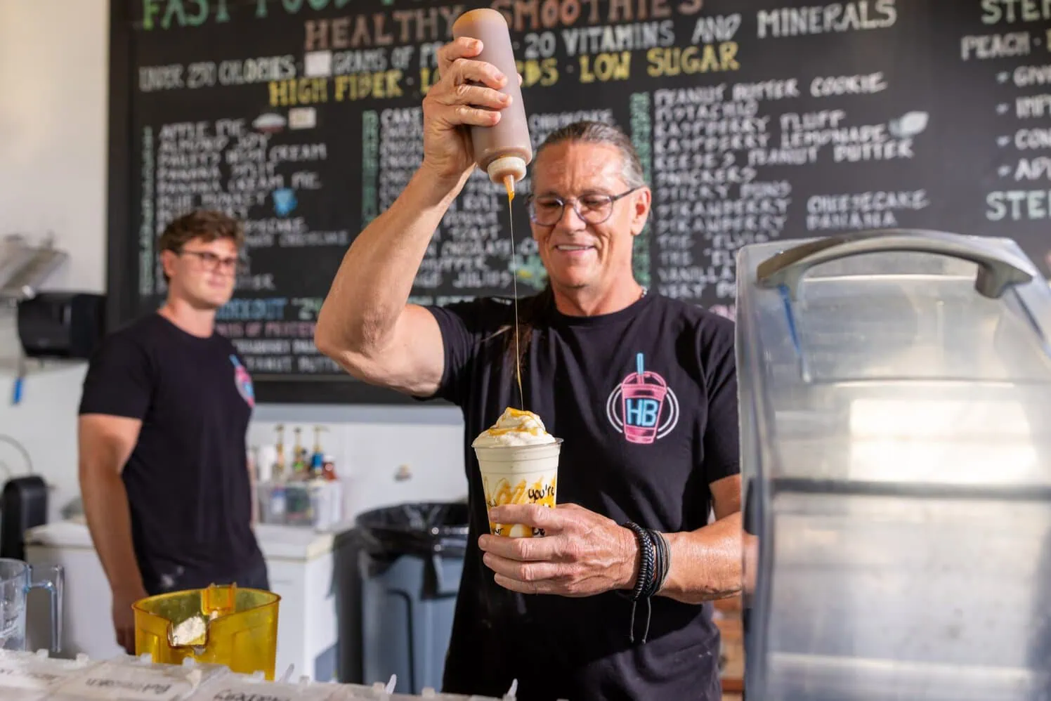 Daniel Boone adds the finishing touch to an HB Protein Smoothie at the brand’s flagship Scottsdale location. Image Courtesy of HB Protein Smoothies.
