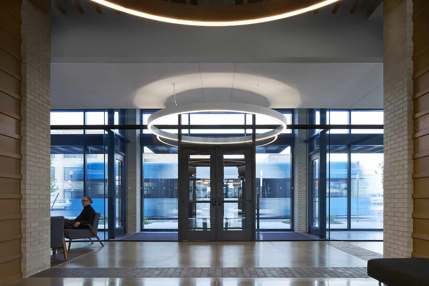 Interior view of the Heartland Headquarters lobby, featuring modern circular lighting fixtures and glass entrance doors."