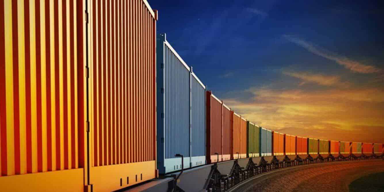 Rail container freight train in the sunset carrying containers