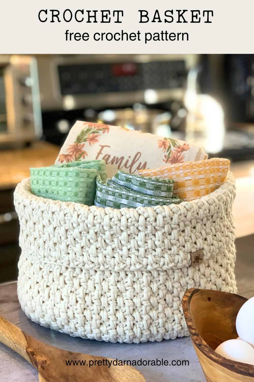 cream crochet basket pattern filled with kitchen towels