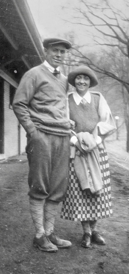 chick_catherine Vintage black and white photo of a smiling young man and woman outdoors, dressed in early 20th-century attire, showcasing historical fashion and daily life.