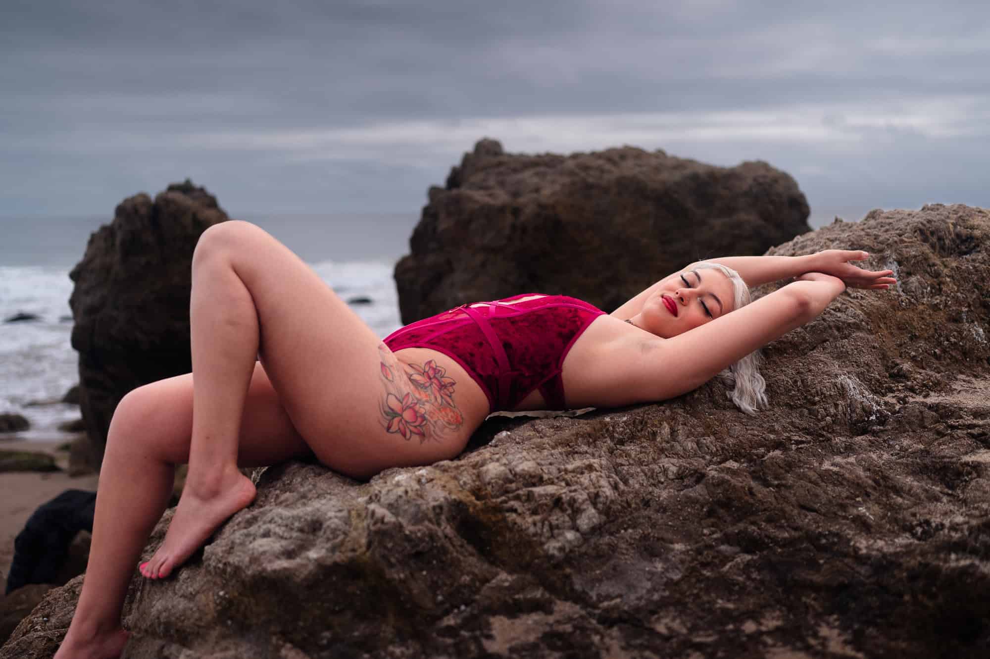 lying down beach boudoir shoot idea on rocks in los angeles