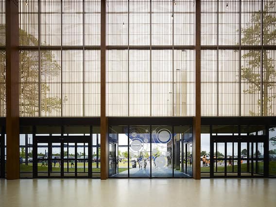 Interior view of Science Museum Oklahoma's grand entrance with glass facade and circular design accents.