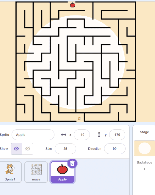 Scratch maze game scene showing a maze backdrop with an apple sprite placed near the top of the level