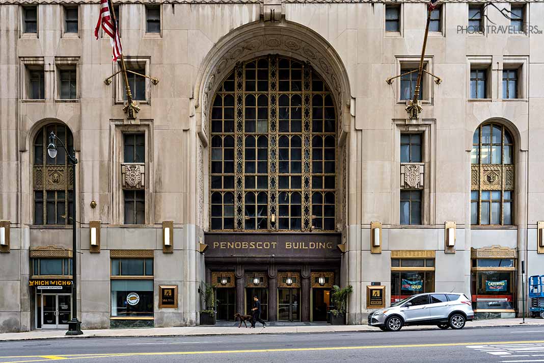 Ein Passant mit Hund vor dem Eingang des Penobscot Buildings